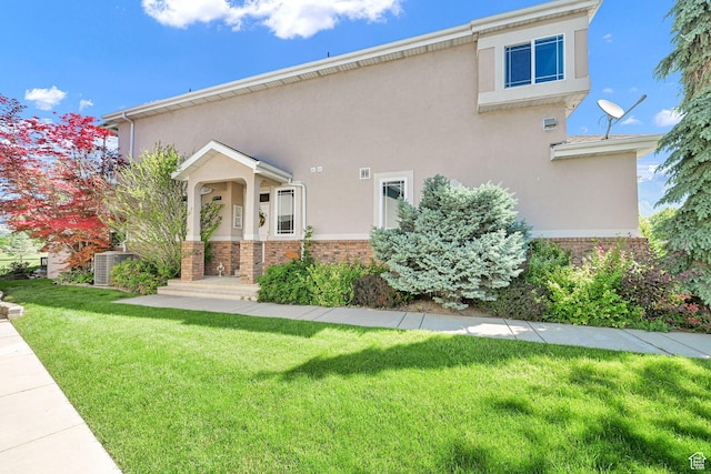 97 Hillsborough Dr, Pleasant View, UT 84414 - view of front of property featuring a front lawn, stucco siding, and brick siding