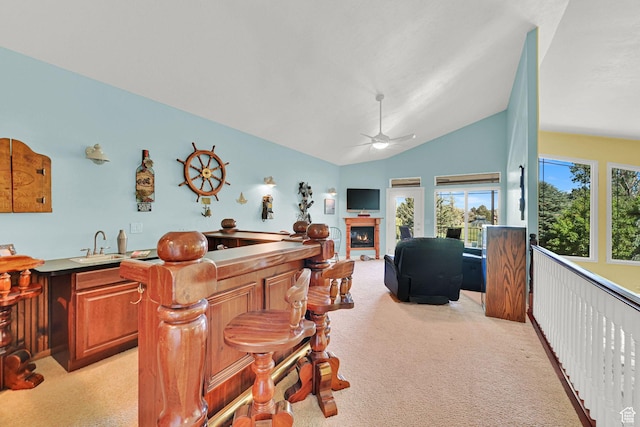 97 Hillsborough Dr, Pleasant View, UT 84414 - bar area with light colored carpet, a lit fireplace, a ceiling fan, and lofted ceiling