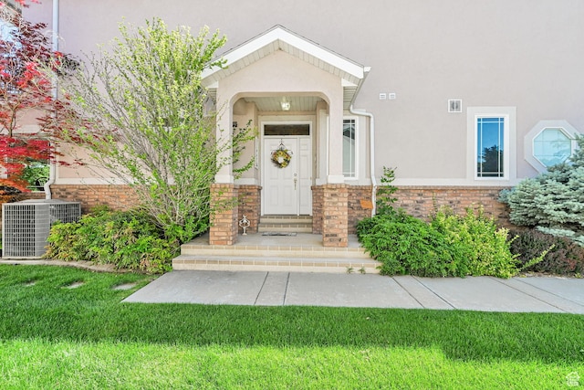 97 Hillsborough Dr, Pleasant View, UT 84414 - entrance to property featuring stucco siding, a yard, and brick siding