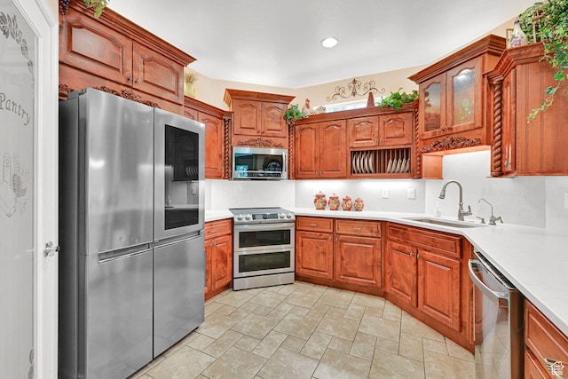 97 Hillsborough Dr, Pleasant View, UT 84414 - kitchen featuring appliances with stainless steel finishes, light stone finish flooring, light countertops, and brown cabinetry