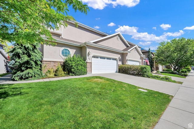 97 Hillsborough Dr, Pleasant View, UT 84414 - view of front of property with stucco siding, concrete driveway, a front yard, and an attached garage
