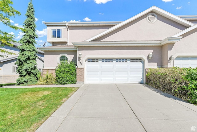 97 Hillsborough Dr, Pleasant View, UT 84414 - traditional home with stucco siding, driveway, an attached garage, and a front lawn