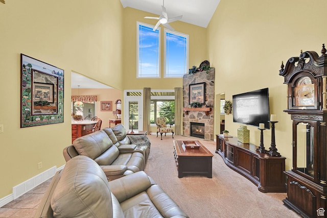 97 Hillsborough Dr, Pleasant View, UT 84414 - living room featuring a towering ceiling, a ceiling fan, a stone fireplace, and carpet floors