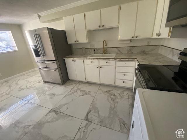 314 W Center St N Unit 135, Bountiful, UT 84010 - kitchen with appliances with stainless steel finishes, white cabinetry, light countertops, ornamental molding, and light marble finish flooring
