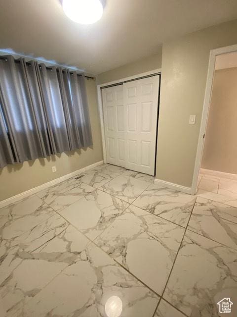 314 W Center St N Unit 135, Bountiful, UT 84010 - unfurnished bedroom featuring a closet and light marble finish flooring