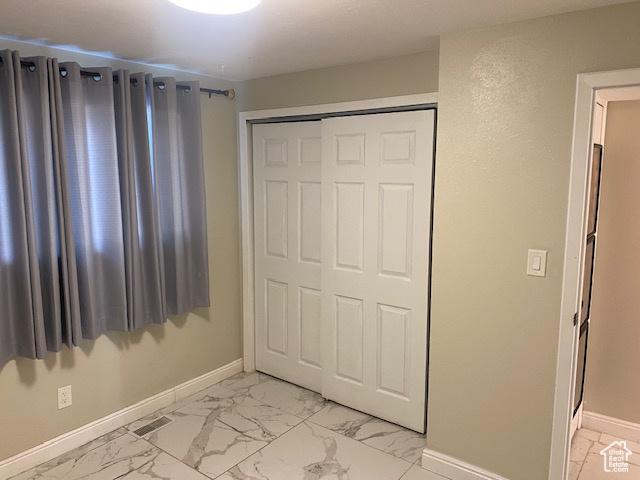 314 W Center St N Unit 135, Bountiful, UT 84010 - unfurnished bedroom featuring light marble finish floors and a closet