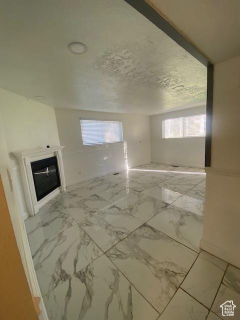 314 W Center St N Unit 135, Bountiful, UT 84010 - unfurnished living room with a glass covered fireplace and light marble finish flooring