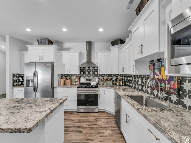 354 E 370 S, Kamas, UT 84036 - kitchen with appliances with stainless steel finishes, wall chimney exhaust hood, dark wood-type flooring, white cabinets, and recessed lighting