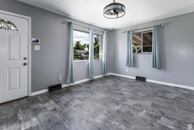 317 Highland Dr, Tooele, UT 84074 - entryway featuring wood finished floors and a textured ceiling