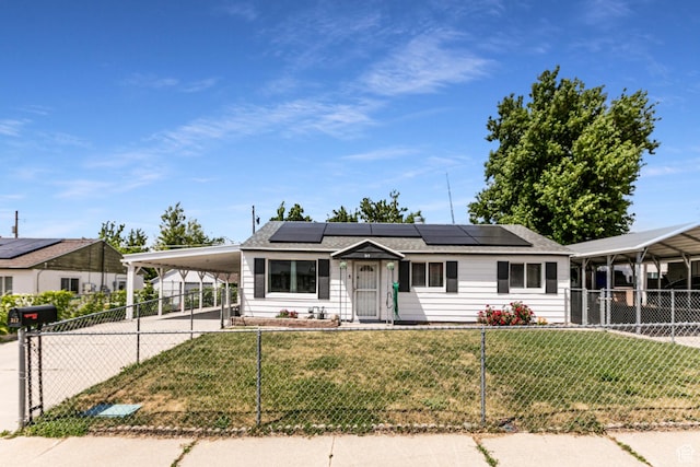 317 Highland Dr, Tooele, UT 84074 - view of front facade with a carport, concrete driveway, and solar panels