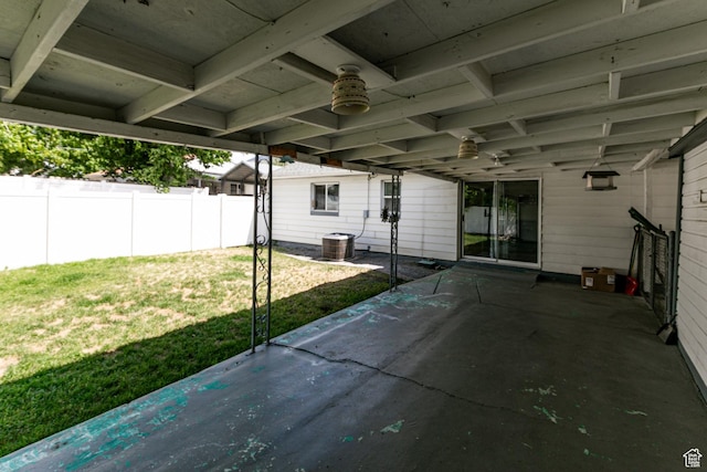 317 Highland Dr, Tooele, UT 84074 - fenced backyard with a patio area, ceiling fan, and a carport