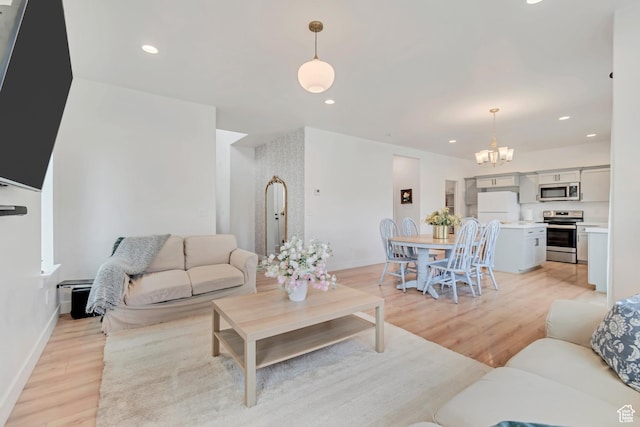 7256 N Green Pasture Ln, Eagle Mountain, UT 84005 - living room featuring light wood-style flooring, a chandelier, and recessed lighting