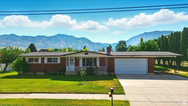 2280 N 800 E, North Logan, UT 84341 - single story home with a mountain view, an attached garage, a front yard, concrete driveway, and a chimney