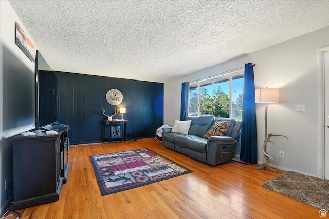 2280 N 800 E, North Logan, UT 84341 - living room with light wood-type flooring, a textured ceiling, and an accent wall