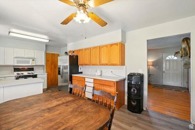 2280 N 800 E, North Logan, UT 84341 - kitchen featuring white appliances, ceiling fan, wood finished floors, light countertops, and white cabinetry
