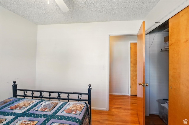 2280 N 800 E, North Logan, UT 84341 - bedroom featuring wood finished floors, a textured ceiling, a closet, and a ceiling fan