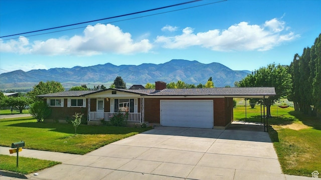 2280 N 800 E, North Logan, UT 84341 - ranch-style house featuring a porch, a mountain view, an attached garage, and a front yard
