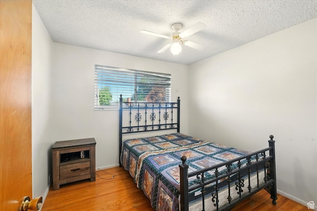 2280 N 800 E, North Logan, UT 84341 - bedroom with wood finished floors, a textured ceiling, and a ceiling fan