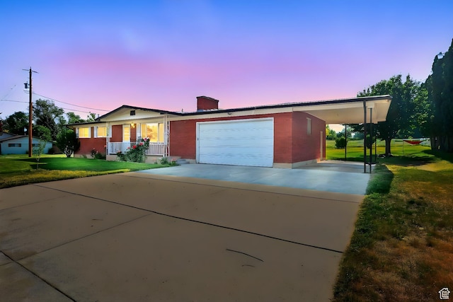 2280 N 800 E, North Logan, UT 84341 - single story home featuring covered porch, concrete driveway, a carport, a front lawn, and an attached garage