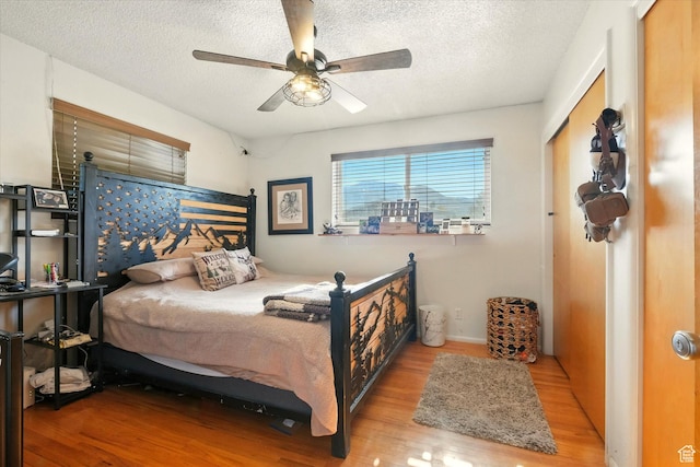 2280 N 800 E, North Logan, UT 84341 - bedroom featuring wood finished floors, a textured ceiling, and ceiling fan