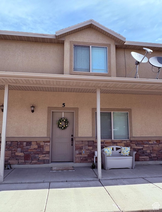 815 N 100 E Unit 5, Brigham City, UT 84302 - property entrance with stone siding, stucco siding, and covered porch