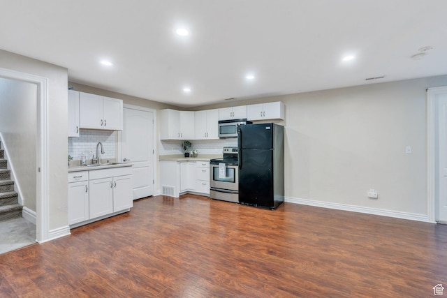 215 N Bald Mountain Dr E, Alpine, UT 84004 - kitchen featuring stainless steel appliances, backsplash, light countertops, dark wood-style flooring, and white cabinetry