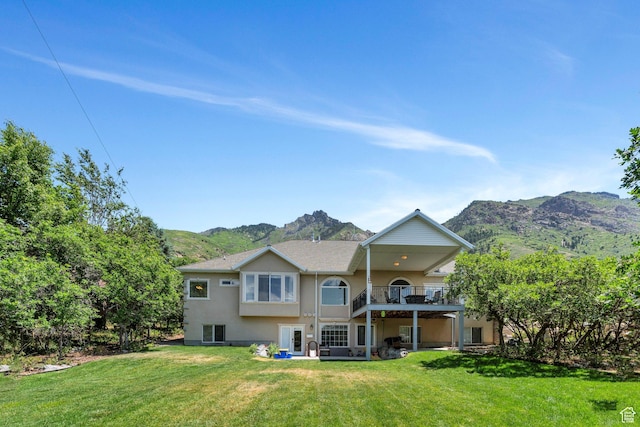215 N Bald Mountain Dr E, Alpine, UT 84004 - rear view of house featuring a mountain view, stucco siding, and a yard