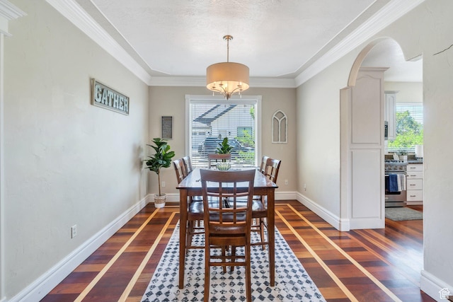 215 N Bald Mountain Dr E, Alpine, UT 84004 - dining area featuring dark wood-style floors, arched walkways, and crown molding