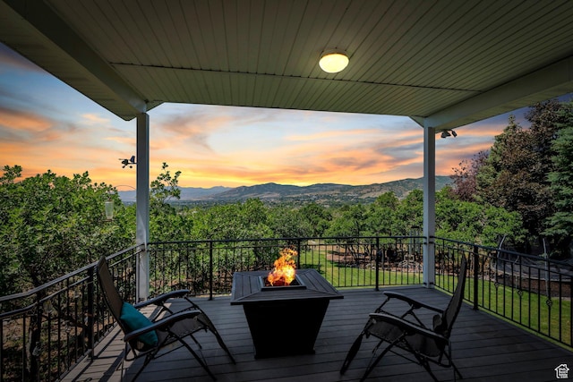 215 N Bald Mountain Dr E, Alpine, UT 84004 - deck at dusk with an outdoor fire pit and a mountain view