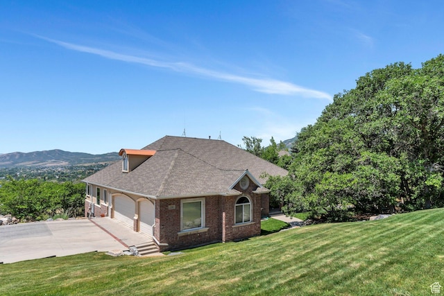 215 N Bald Mountain Dr E, Alpine, UT 84004 - view of side of property with brick siding, concrete driveway, a lawn, a garage, and roof with shingles