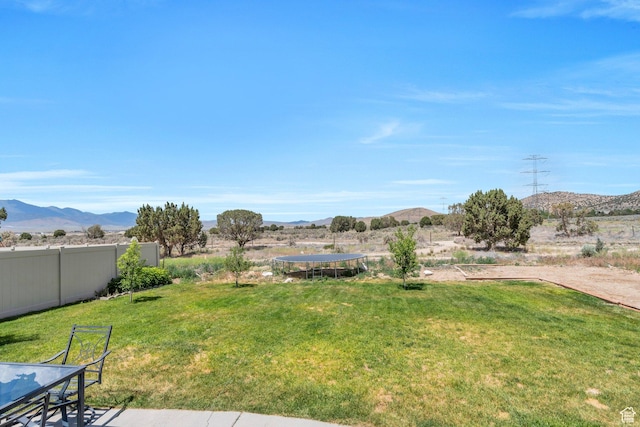 2459 E Ox Yoke Dr S, Eagle Mountain, UT 84005 - view of yard with a trampoline and a mountain view