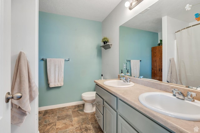 2459 E Ox Yoke Dr S, Eagle Mountain, UT 84005 - bathroom with double vanity, stone finish floors, a textured ceiling, and a shower with curtain