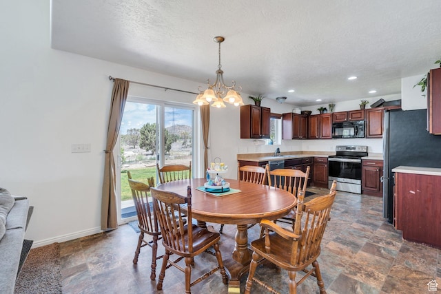 2459 E Ox Yoke Dr S, Eagle Mountain, UT 84005 - dining space with a chandelier, a textured ceiling, recessed lighting, and stone finish flooring