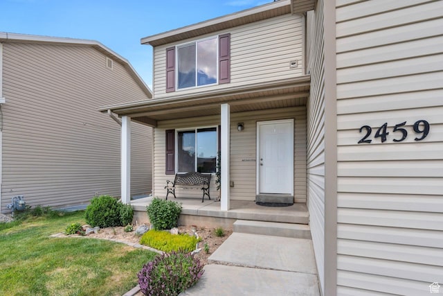2459 E Ox Yoke Dr S, Eagle Mountain, UT 84005 - view of exterior entry featuring a porch and a lawn