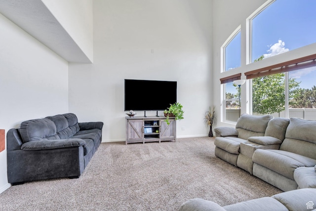 2459 E Ox Yoke Dr S, Eagle Mountain, UT 84005 - carpeted living room featuring a high ceiling and baseboards