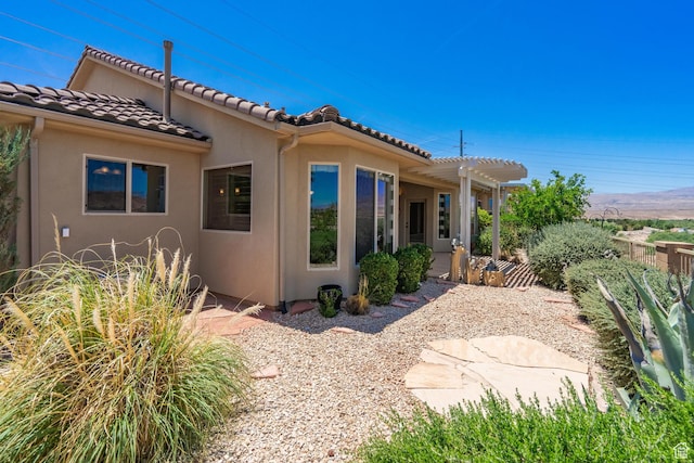 1410 W Ambassador Dr, St George, UT 84790 - rear view of house with stucco siding and a tile roof