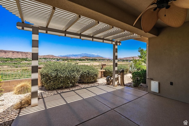 1410 W Ambassador Dr, St George, UT 84790 - view of patio featuring a mountain view, a ceiling fan, and a pergola