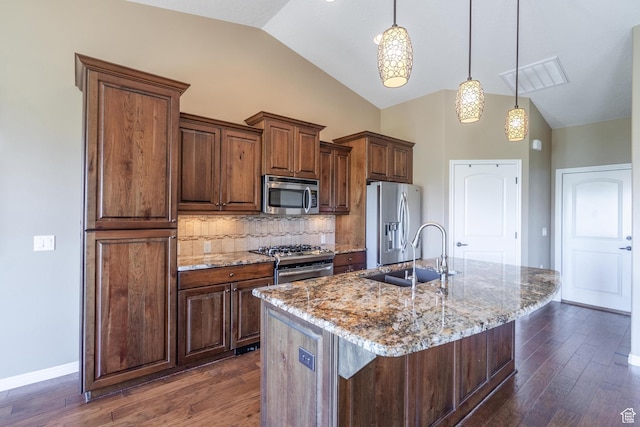 1410 W Ambassador Dr, St George, UT 84790 - kitchen with stainless steel appliances, dark wood-type flooring, an island with sink, tasteful backsplash, and light stone countertops