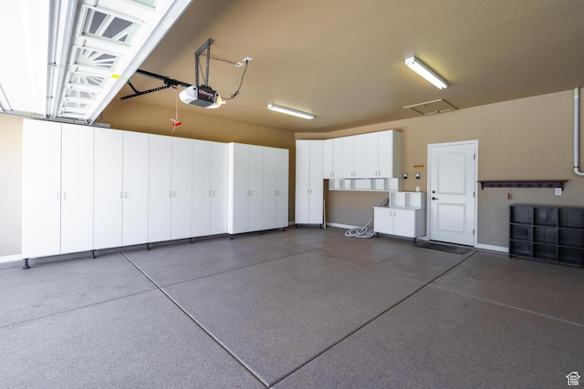 1410 W Ambassador Dr, St George, UT 84790 - garage with a garage door opener and baseboards
