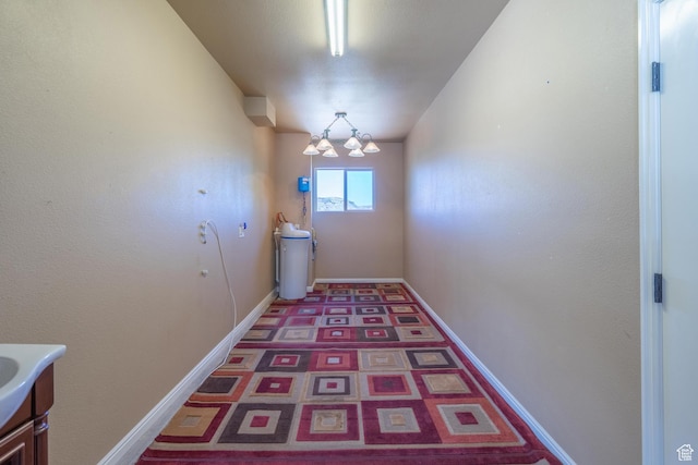1410 W Ambassador Dr, St George, UT 84790 - hallway featuring a chandelier and baseboards