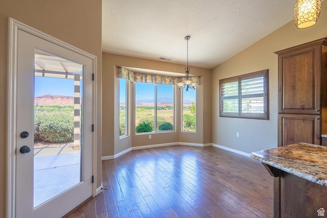 1410 W Ambassador Dr, St George, UT 84790 - unfurnished dining area with vaulted ceiling, a chandelier, dark wood-style floors, and a textured ceiling