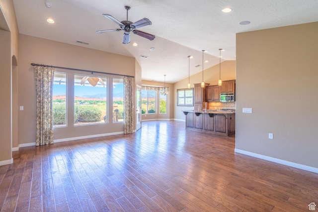 1410 W Ambassador Dr, St George, UT 84790 - unfurnished living room with a ceiling fan, dark wood-style floors, recessed lighting, and high vaulted ceiling