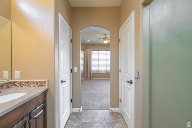 1410 W Ambassador Dr, St George, UT 84790 - bathroom featuring a ceiling fan, vanity, and decorative backsplash