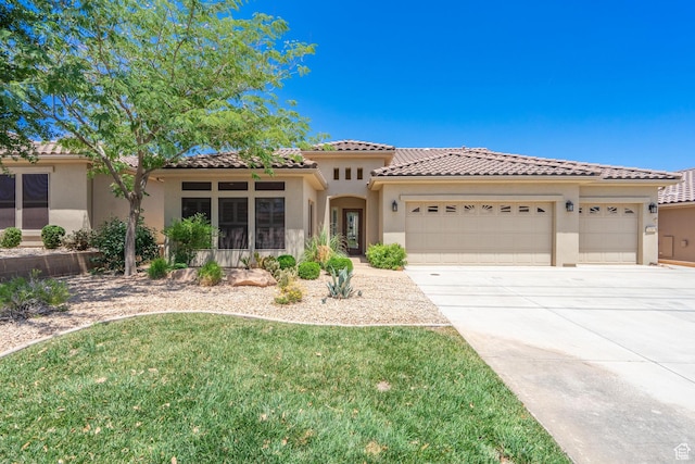 1410 W Ambassador Dr, St George, UT 84790 - mediterranean / spanish house featuring an attached garage, concrete driveway, stucco siding, and a tile roof