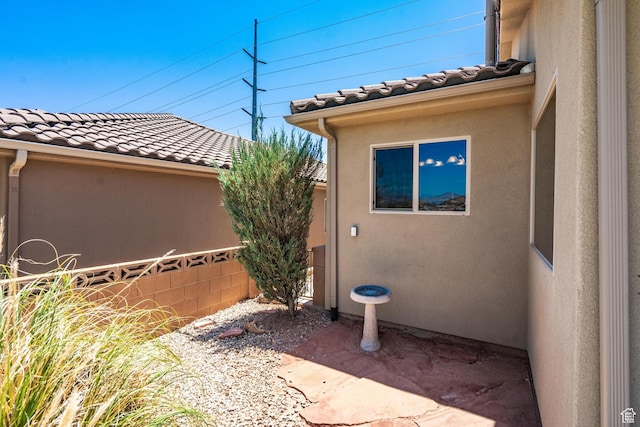 1410 W Ambassador Dr, St George, UT 84790 - view of property exterior featuring a tile roof and stucco siding