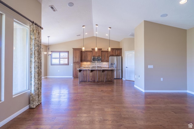 1410 W Ambassador Dr, St George, UT 84790 - kitchen featuring appliances with stainless steel finishes, lofted ceiling, dark wood finished floors, a breakfast bar area, and pendant lighting