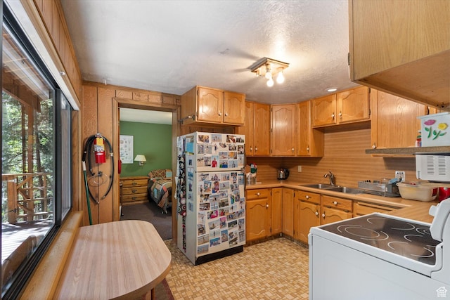 6907 E Mt Aire Rd, Salt Lake City, UT 84109 - kitchen with white appliances, light flooring, light countertops, and a textured ceiling