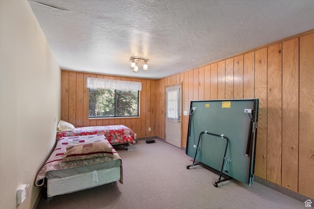 6907 E Mt Aire Rd, Salt Lake City, UT 84109 - bedroom featuring a textured ceiling, carpet, and wood walls
