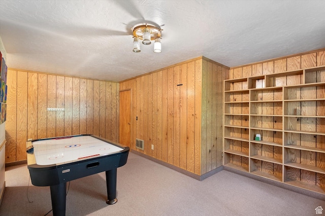 6907 E Mt Aire Rd, Salt Lake City, UT 84109 - rec room featuring wood walls, a textured ceiling, and carpet floors