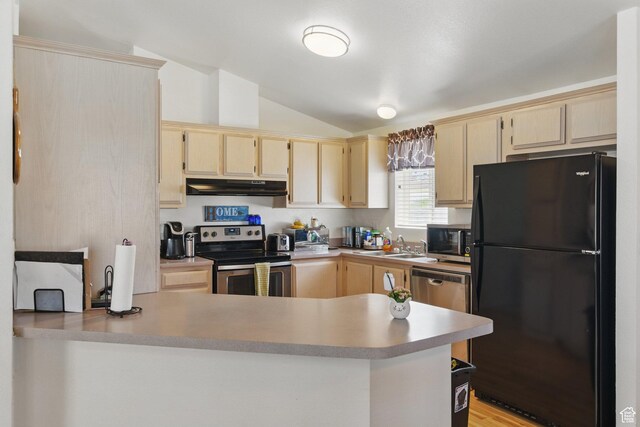 22 E Main St S, Eureka, UT 84628 - kitchen with stainless steel appliances, vaulted ceiling, light brown cabinets, under cabinet range hood, and a peninsula